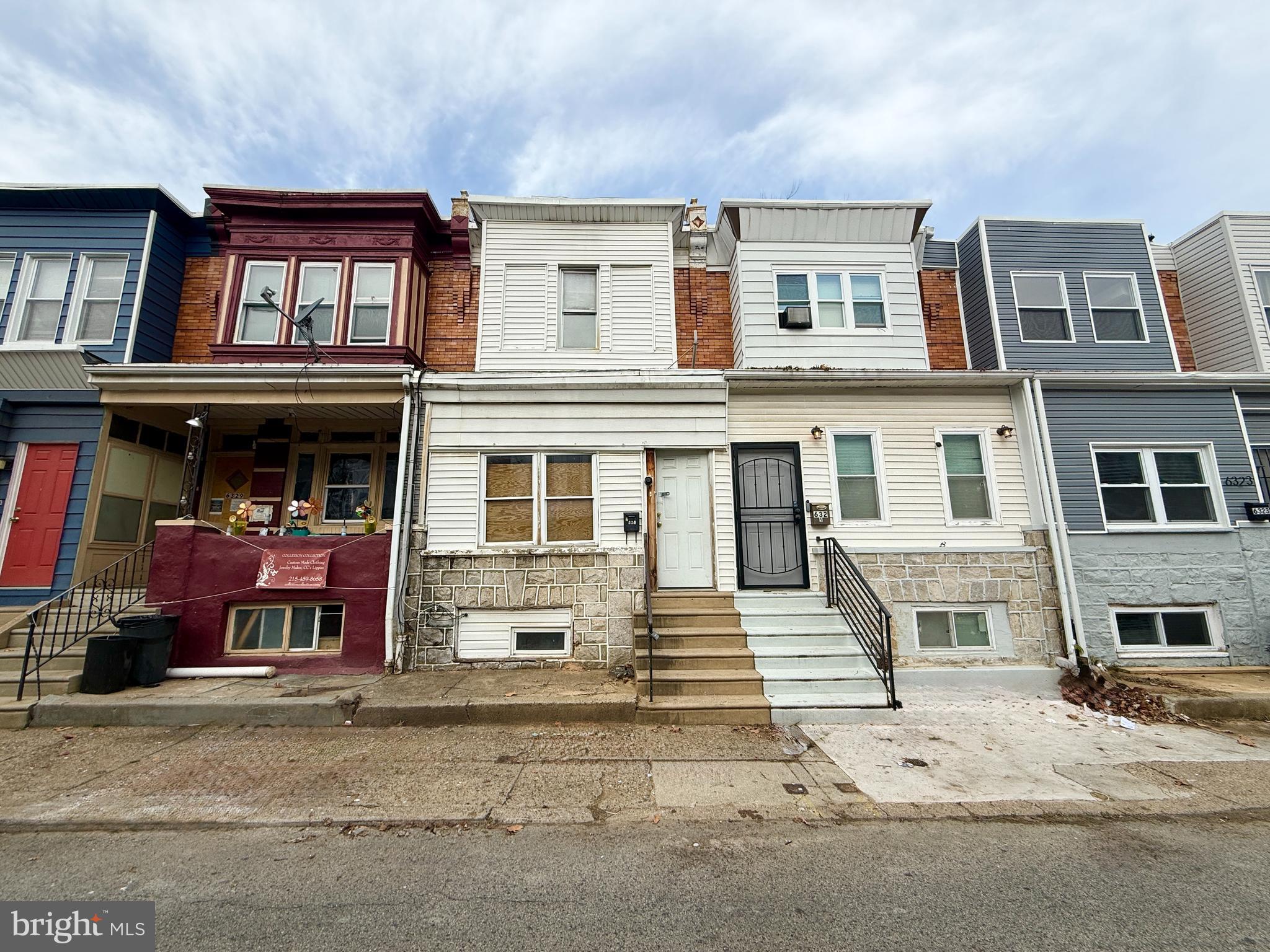 6327 Wheeler Street Philadelphia, PA 19142 - Photo 1 of 36 a front view of a residential apartment building with a yard