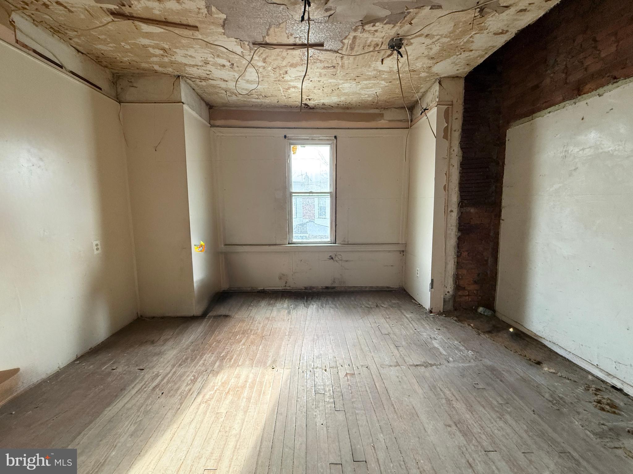 6327 Wheeler Street Philadelphia, PA 19142 - Photo 29 of 36 a view of an empty room with wooden floor and a window