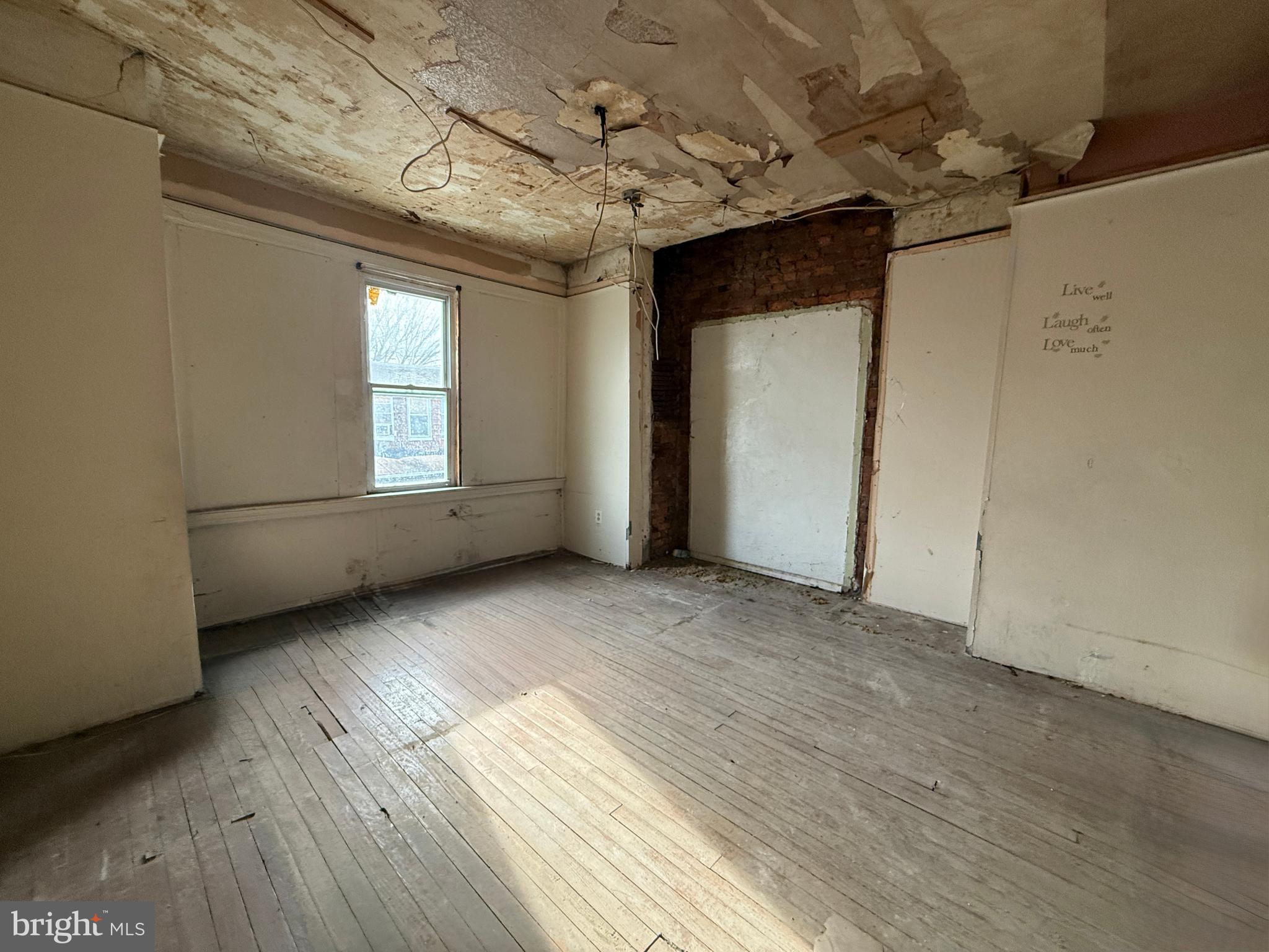6327 Wheeler Street Philadelphia, PA 19142 - Photo 31 of 36 an empty room with wooden floor and windows