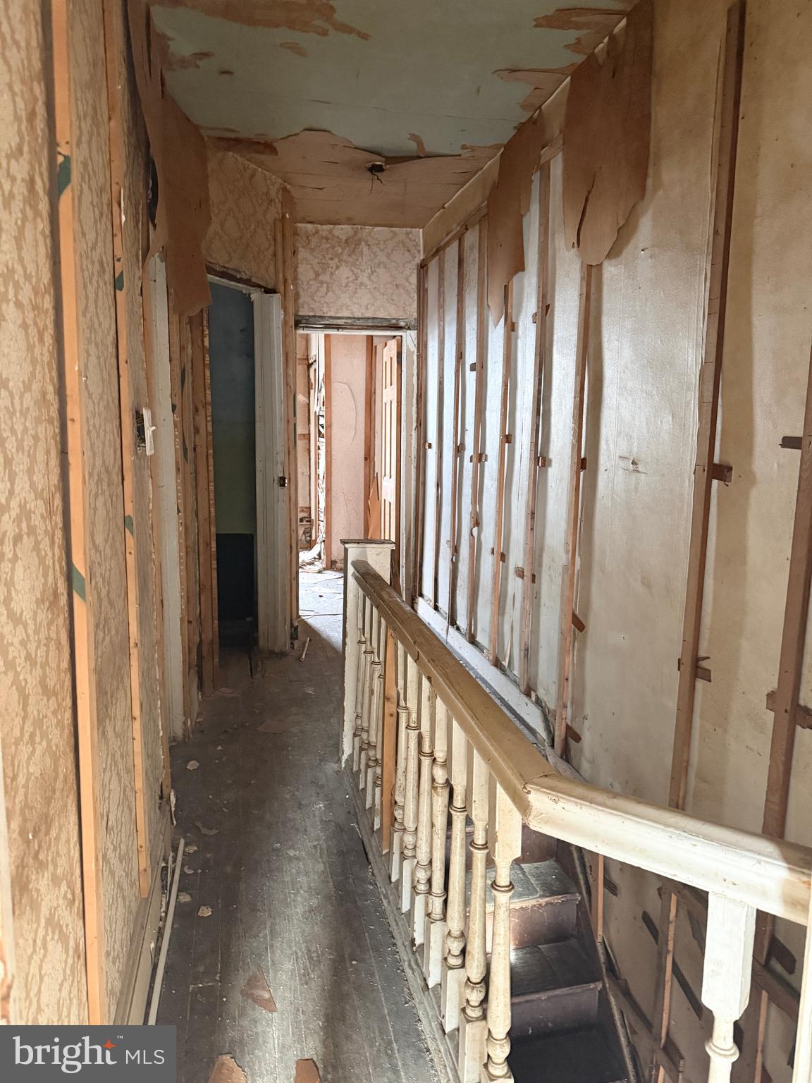 6327 Wheeler Street Philadelphia, PA 19142 - Photo 35 of 36 a view of a hallway with wooden floor and staircase