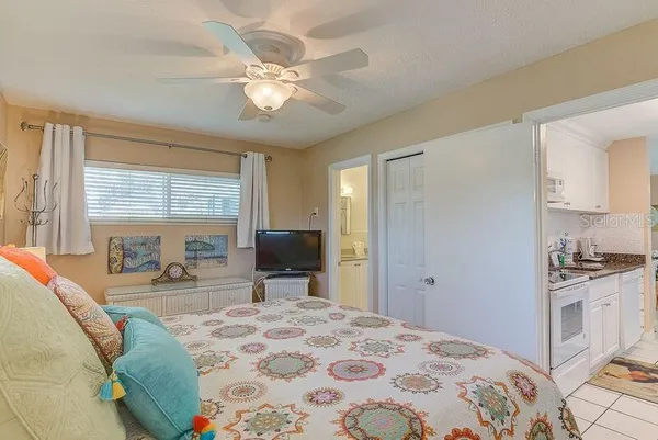 a bedroom with a bed and a chandelier