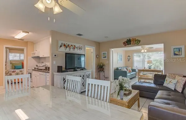 a living room with furniture wooden floor and a flat screen tv