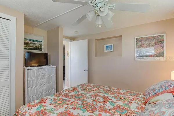 a bedroom with a bed and a tv in it