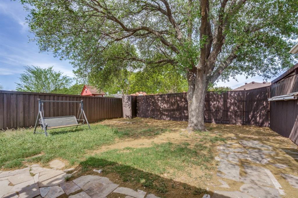 1509 Clover Drive Allen, TX 75002 - Photo 24 of 25 a backyard with table and chairs and a large tree