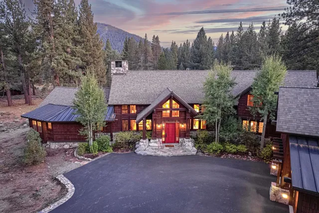 a view of a town with barn and large trees
