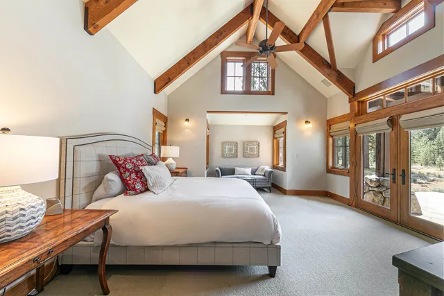 a bedroom with a bed next to a large window