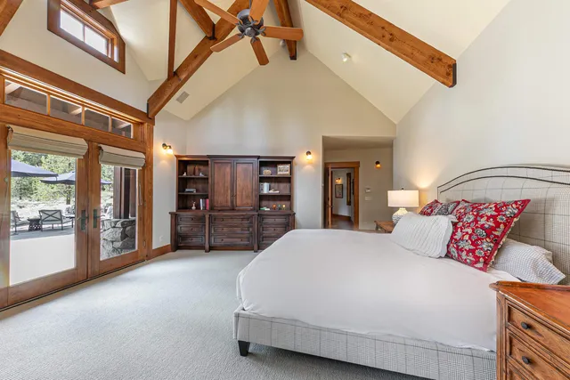 a bedroom with a large bed and a chandelier