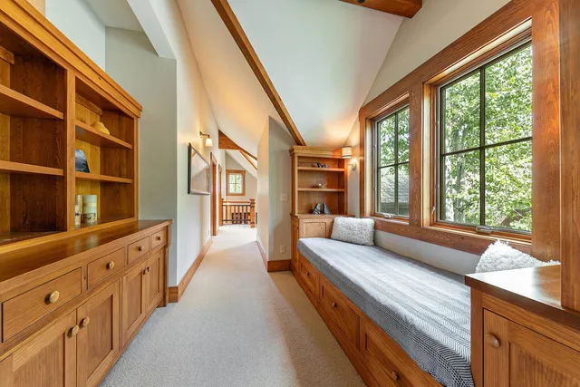 a spacious bathroom with a large window and a walk in closet