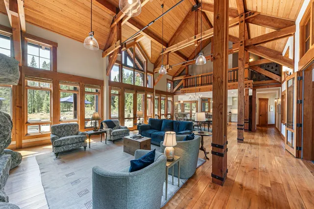 a living room with furniture ceiling fan and a large window