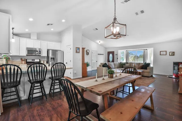 a view of a dining room with furniture wooden floor and chandelier