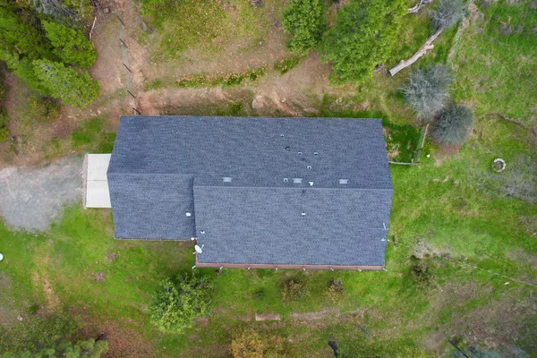 an aerial view of a house with a yard