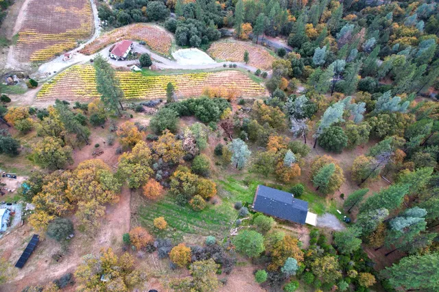 a view of house with yard and outdoor seating