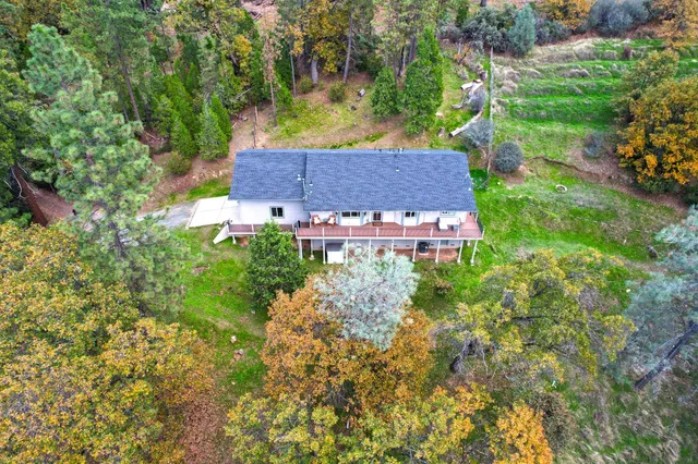 a backyard of a house with table and chairs