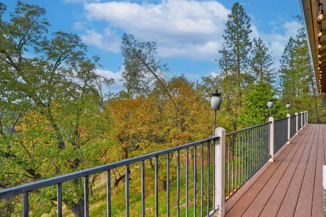 a view of a balcony with wooden fence