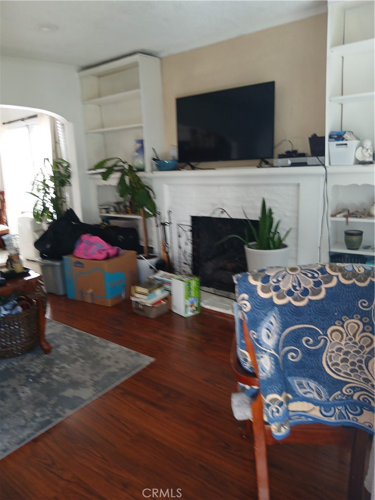 4174 3rd Avenue Los Angeles, CA 90008 - Photo 5 of 5 a living room with furniture a flat screen tv and a fireplace