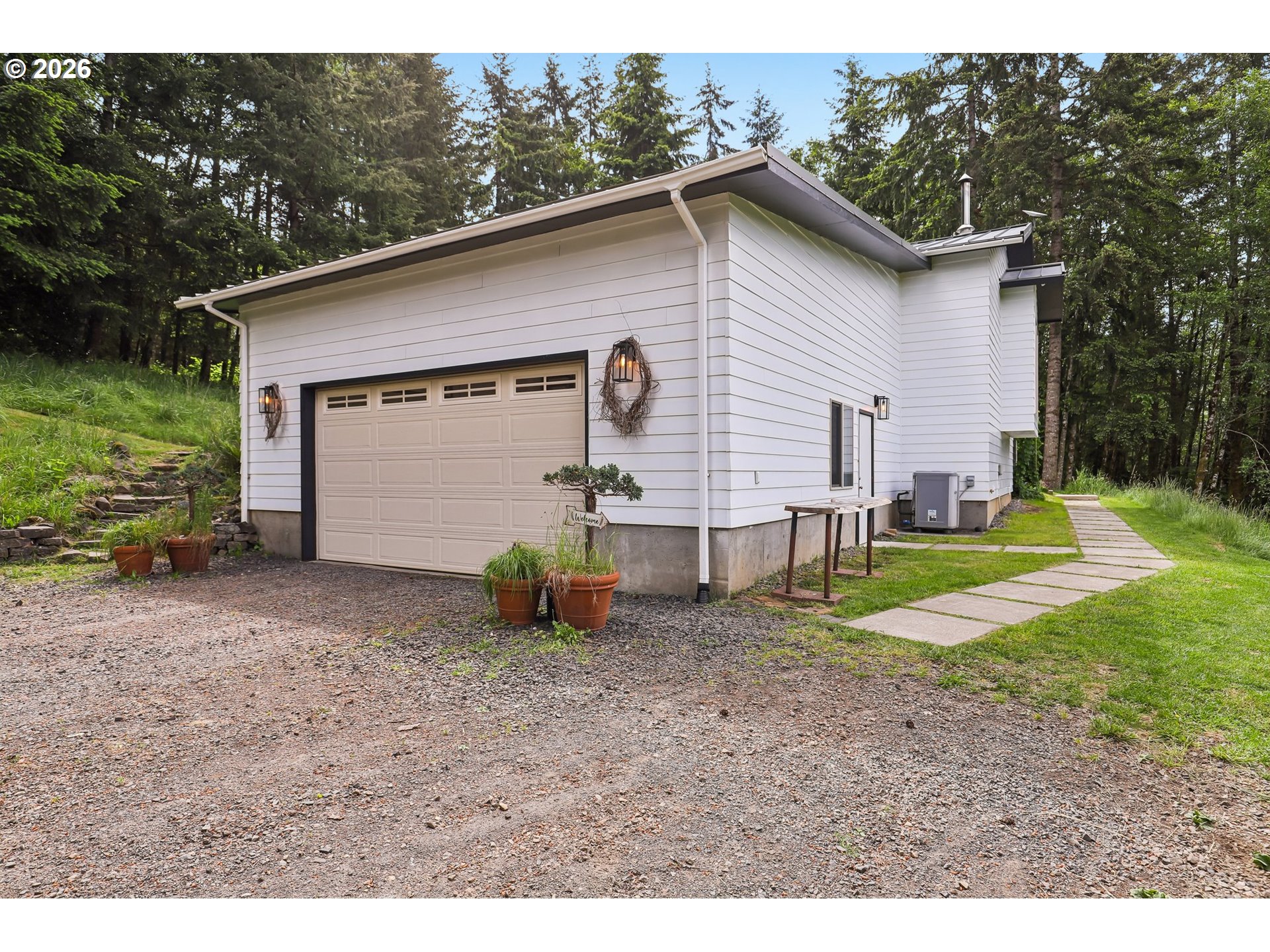 873 Mountain View Road Kalama, WA 98625 - Photo 36 of 45 a view of backyard of house with wooden fence and trees
