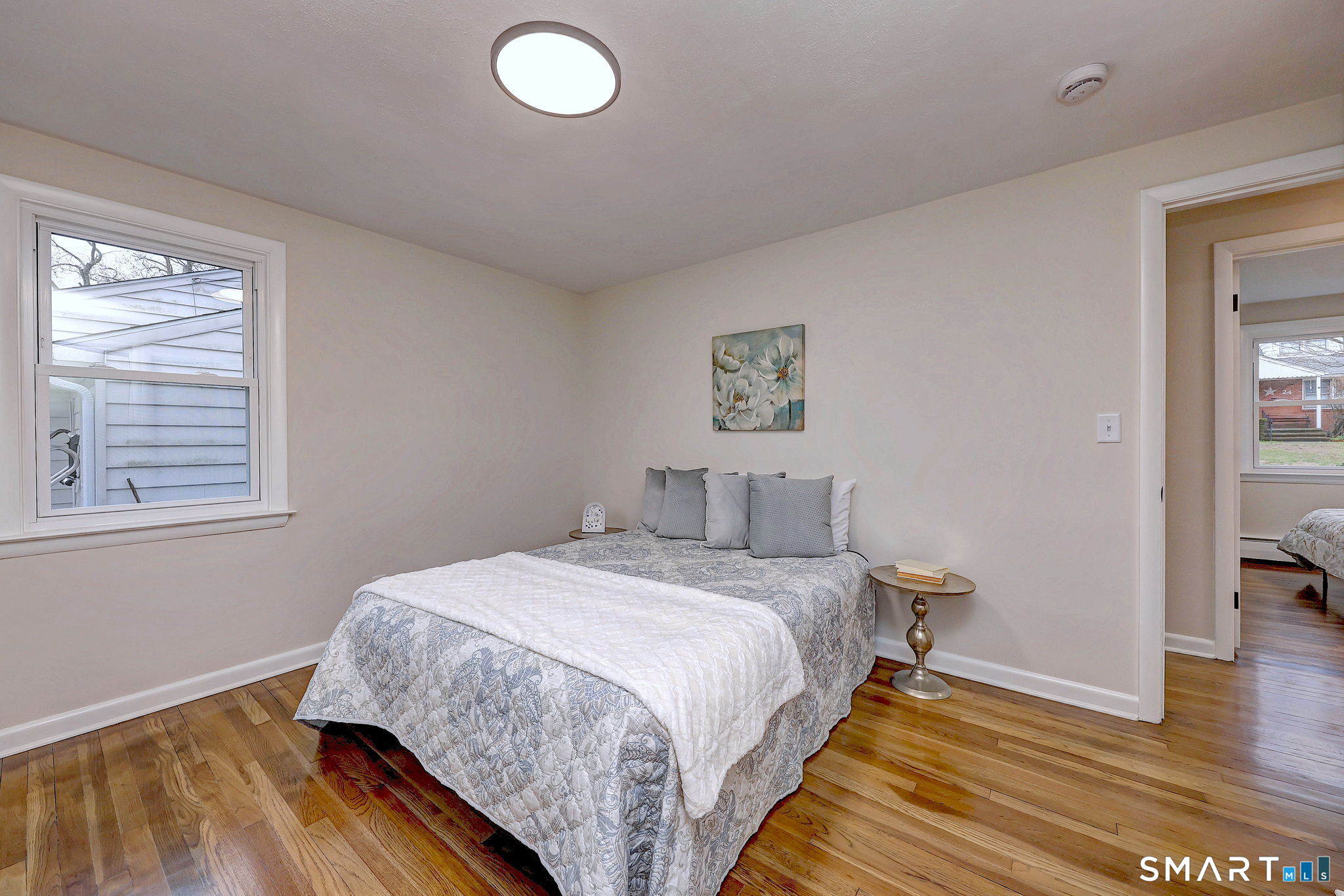 19 Harding Avenue West Haven, CT 06516 - Photo 28 of 39 a bedroom with a bed and wooden floor