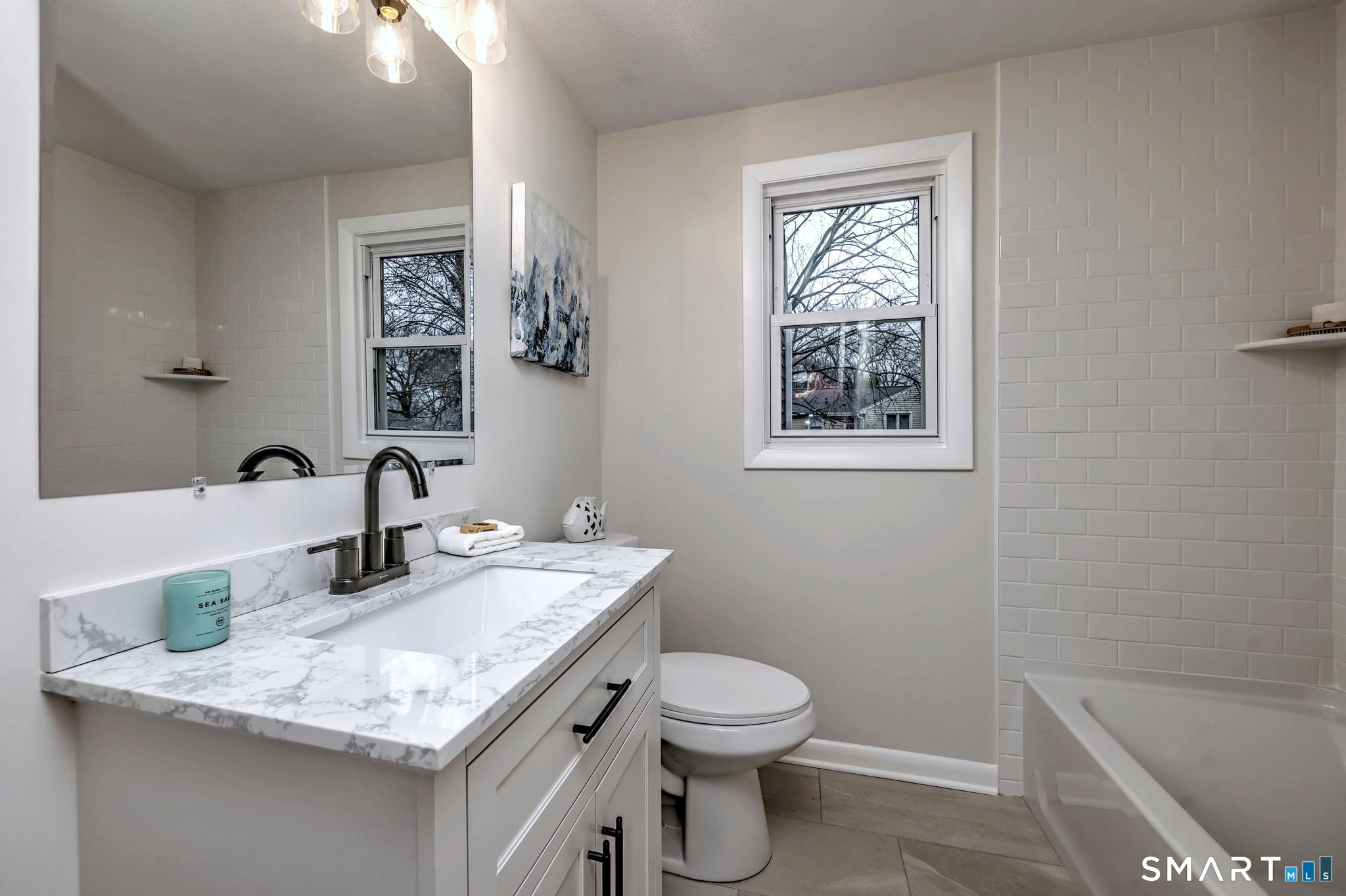 19 Harding Avenue West Haven, CT 06516 - Photo 32 of 39 a bathroom with a granite countertop toilet sink and mirror