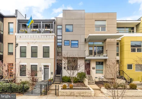 a front view of a residential apartment building with a yard