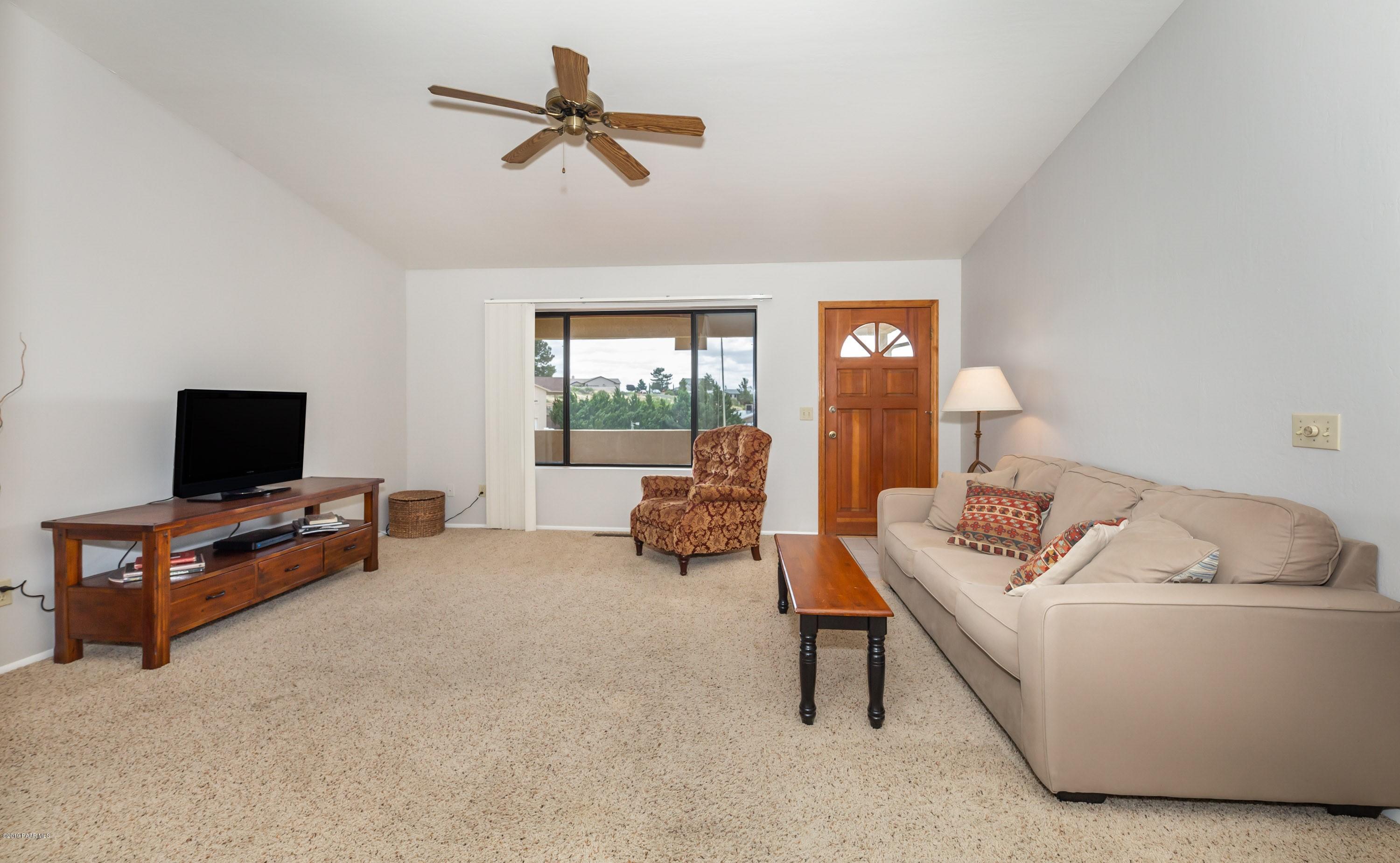 17571 East Hummingbird Lane Mayer, AZ 86333 - Photo 3 of 16 a living room with furniture and a flat screen tv