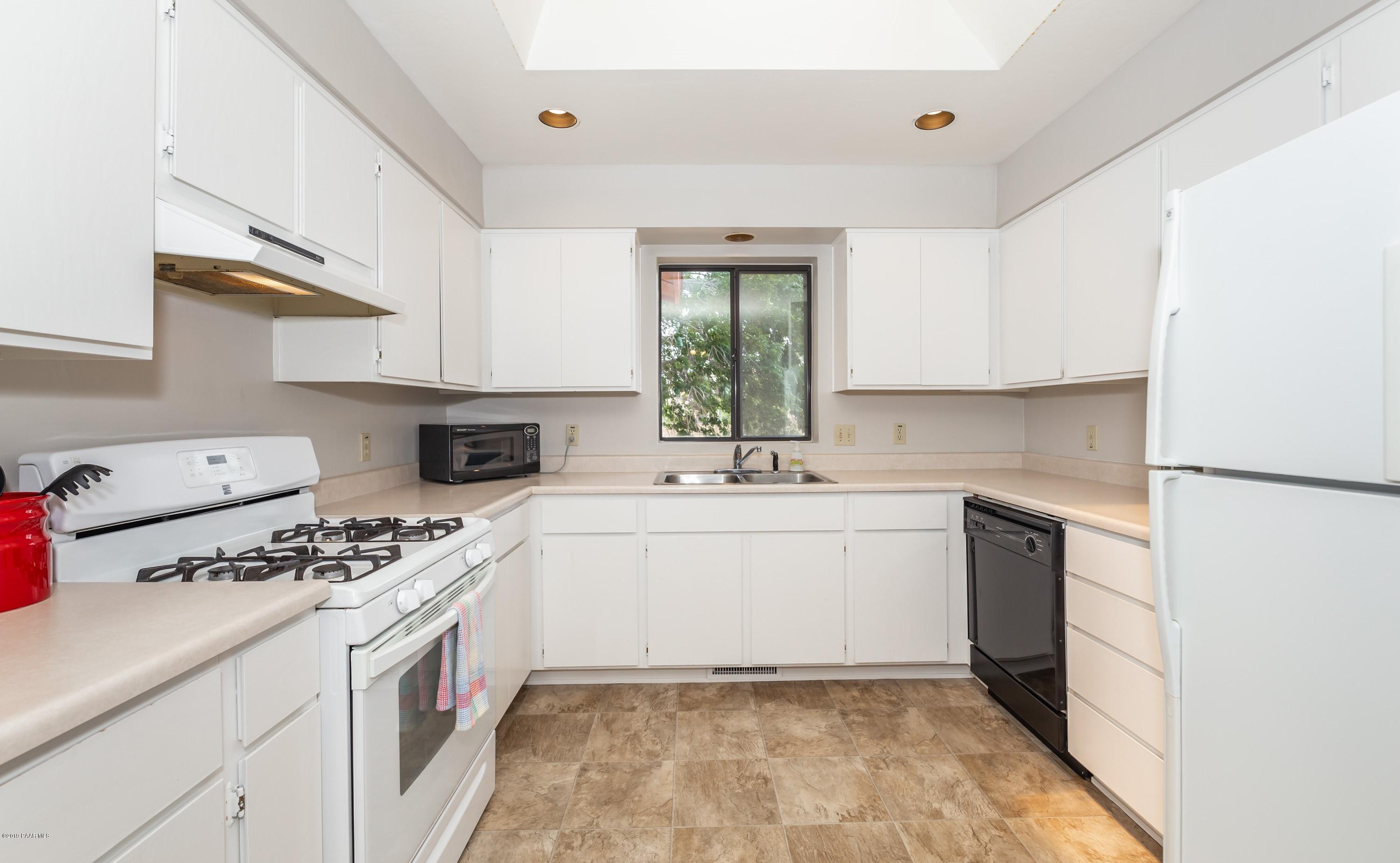 17571 East Hummingbird Lane Mayer, AZ 86333 - Photo 6 of 16 a kitchen with a sink stove and cabinets