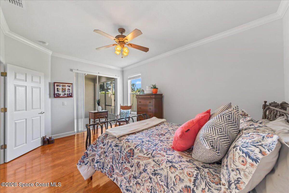 3210 Arden Circle Melbourne, FL 32934 - Photo 17 of 42 a bedroom with a bed and wooden floor