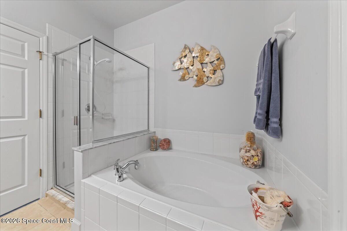 3210 Arden Circle Melbourne, FL 32934 - Photo 19 of 42 a bathroom with a tub and a shower