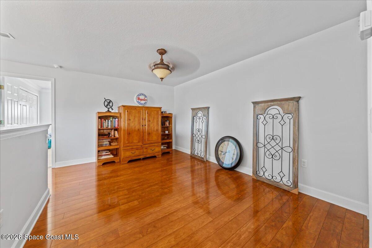 3210 Arden Circle Melbourne, FL 32934 - Photo 23 of 42 a view of room with furniture and wooden floor