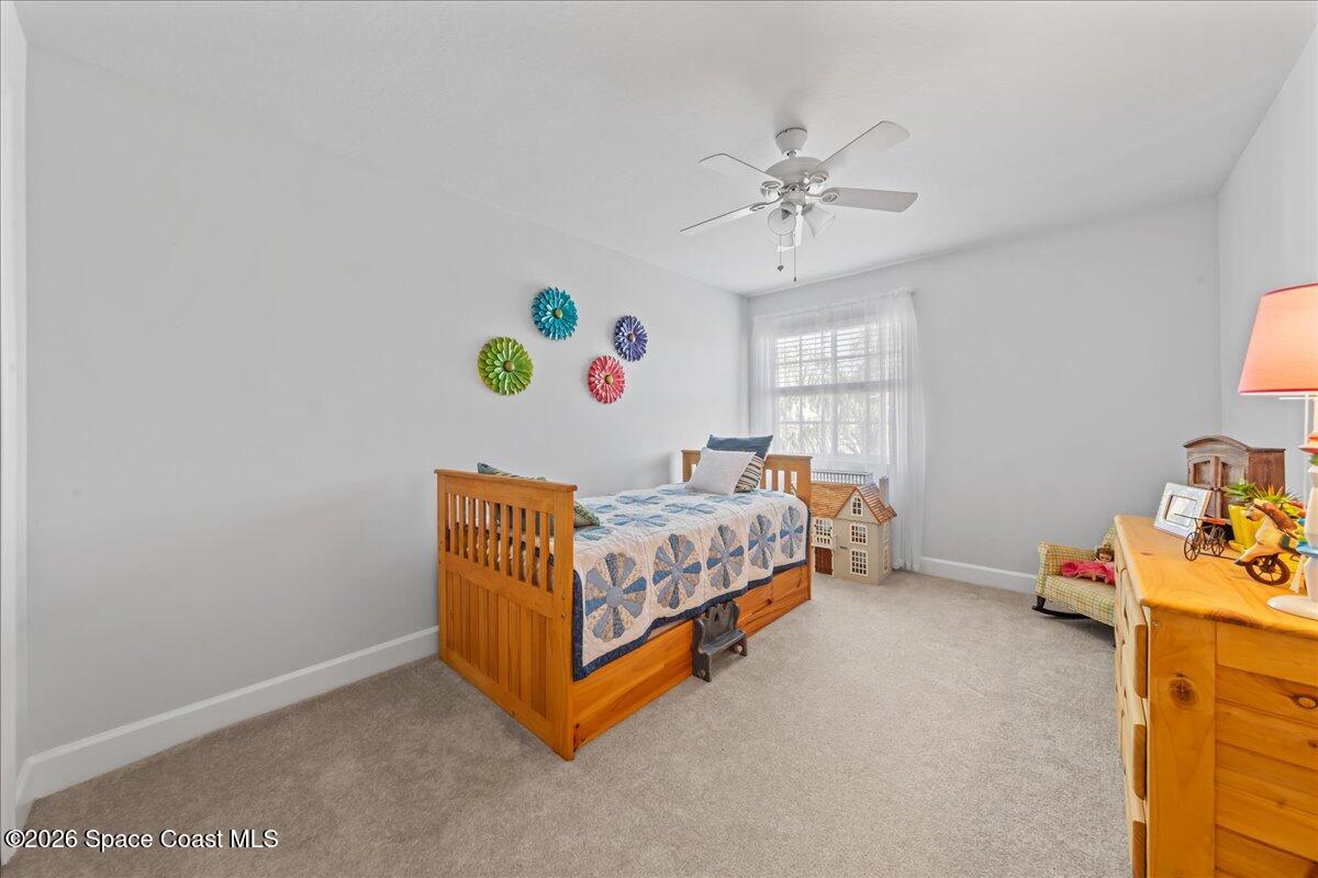 3210 Arden Circle Melbourne, FL 32934 - Photo 25 of 42 a bedroom with a bed and a window