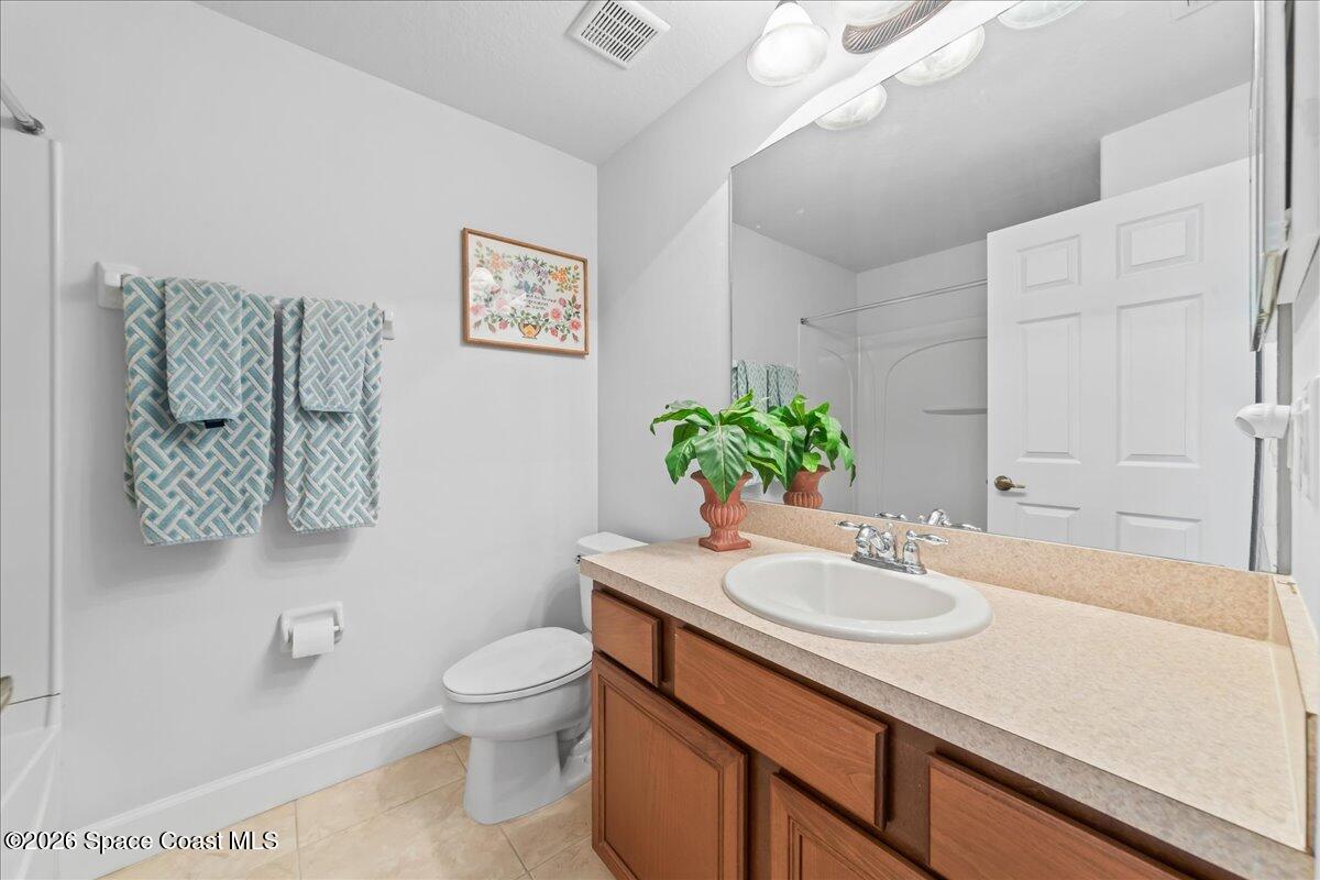 3210 Arden Circle Melbourne, FL 32934 - Photo 27 of 42 a bathroom with a sink a toilet and a mirror
