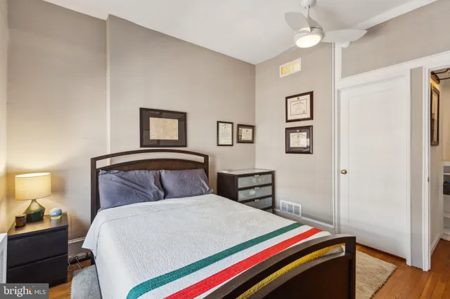 a bedroom with a bed and a lamp on table