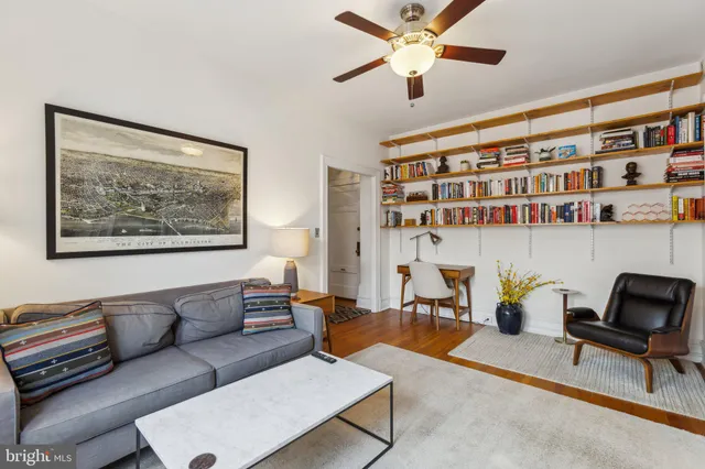 a living room with furniture and a bookshelf