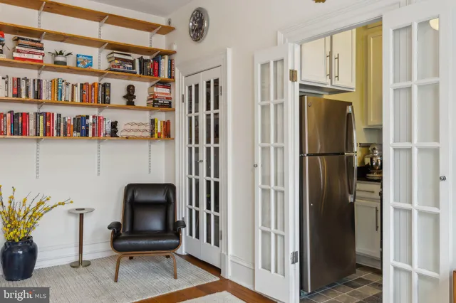 a view of living room with furniture and book shelf