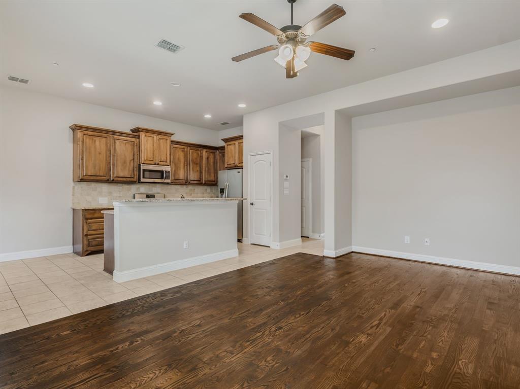 4672 Cecile Road Plano, TX 75024 - Photo 10 of 31 Kitchen with a ceiling fan, recessed lighting, brown cabinets, decorative backsplash, and light wood-style flooring