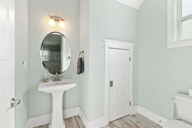 a bathroom with a sink toilet and a mirror
