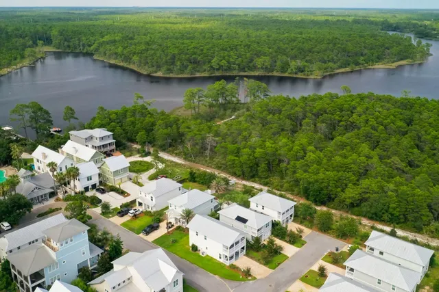 an aerial view of a house with a yard and lake view