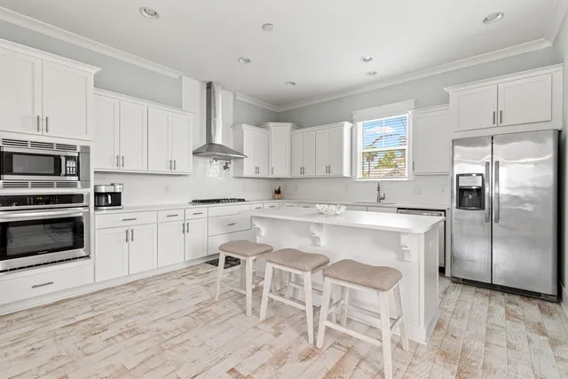 a kitchen with cabinets stainless steel appliances and a window