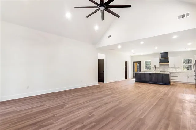 a view of a livingroom with a ceiling fan and wooden floor