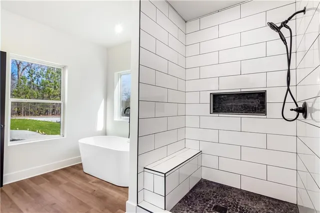 a bathroom with a bathtub and a shower