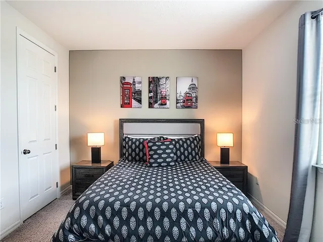 a bedroom with a bed and wall painting