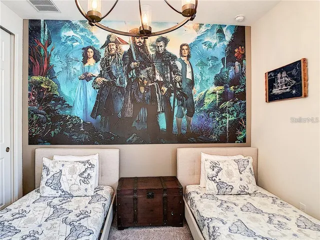a bedroom with a bed and a painting on the wall