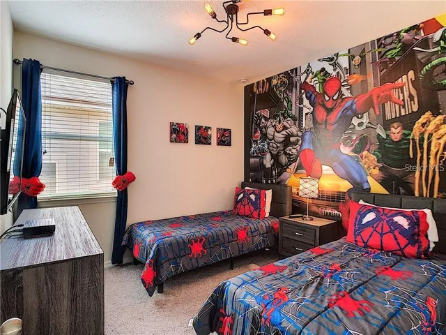 a bedroom with two beds and a window