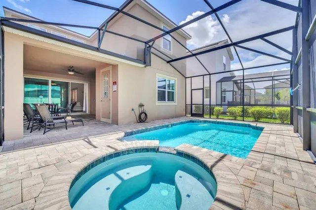 a swimming pool with outdoor seating and yard