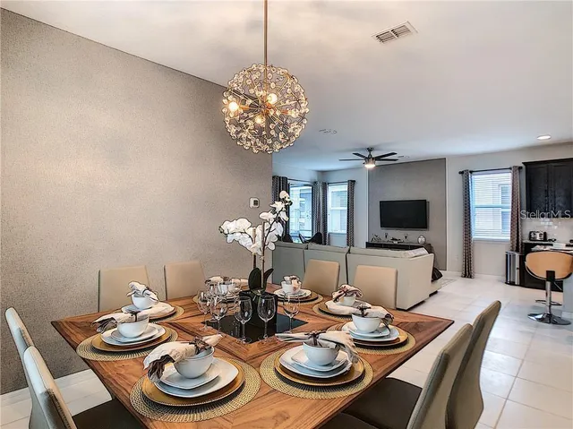 a view of a dining room with furniture wooden floor and chandelier