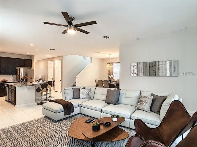a living room with furniture and kitchen view