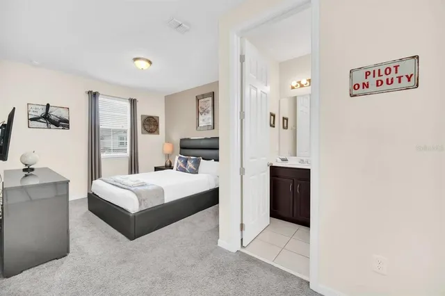 a spacious bedroom with a bed and a couch