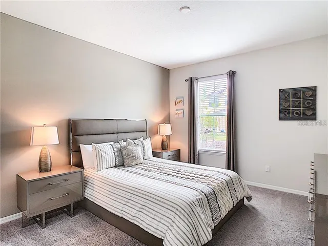 a bedroom with bed and window