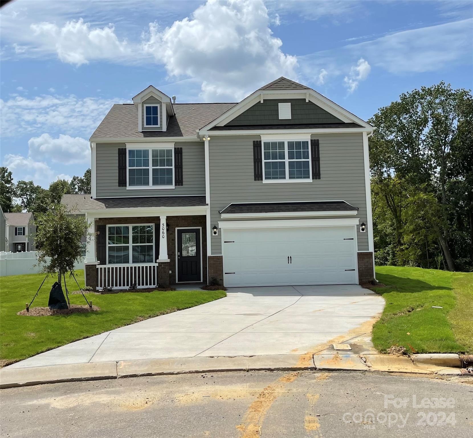 5060 Deisy May Lane Matthews, NC 28105 - Photo 1 of 7 a front view of a house with a yard and garage