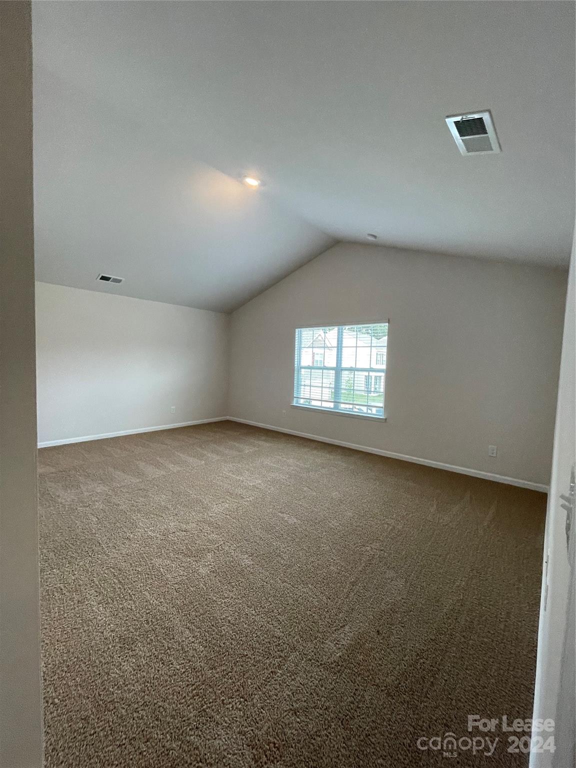 5060 Deisy May Lane Matthews, NC 28105 - Photo 2 of 7 an empty room with windows