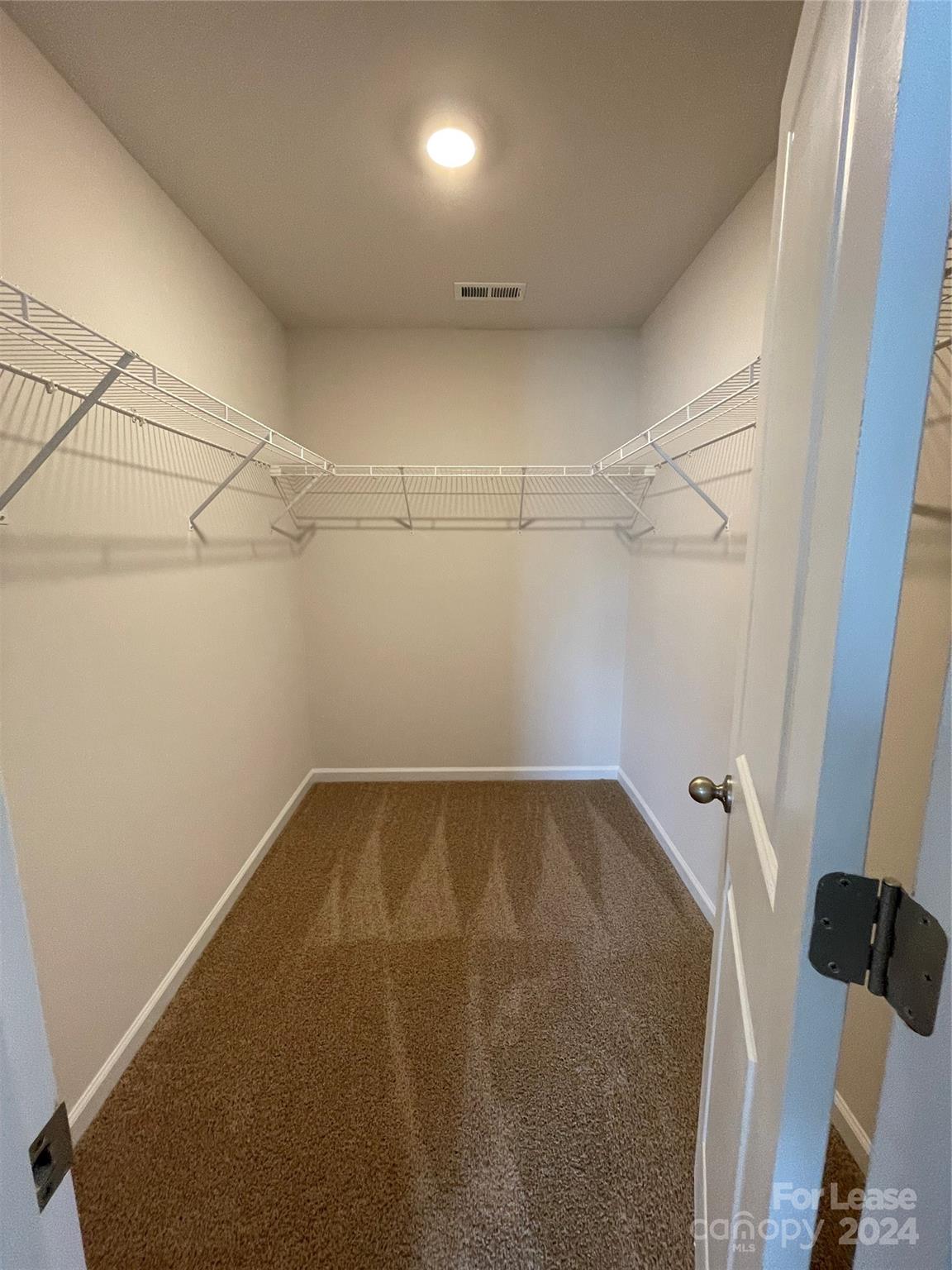 5060 Deisy May Lane Matthews, NC 28105 - Photo 4 of 7 a view of a room with racks on the wall